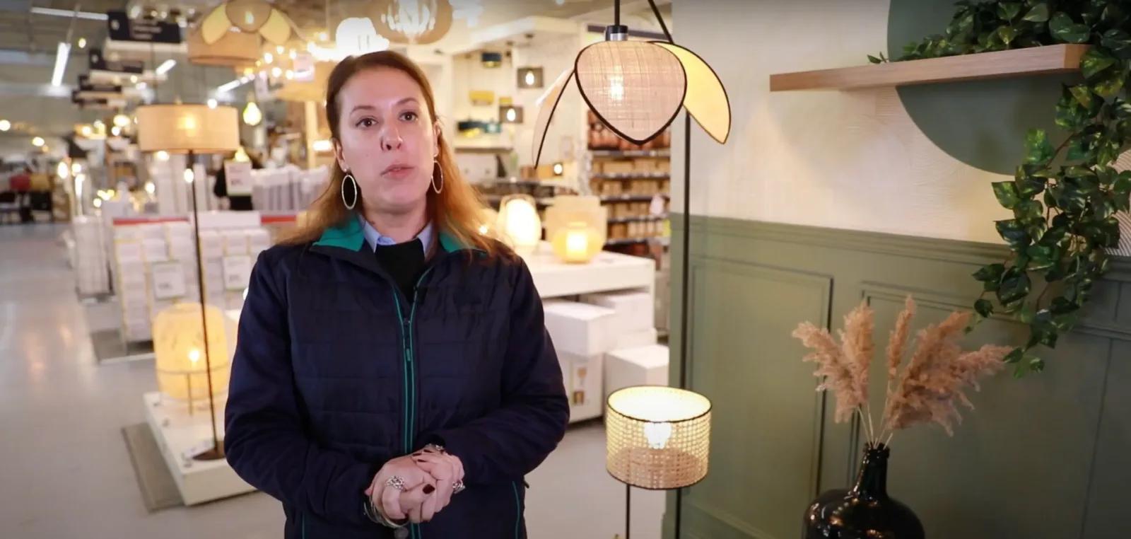Élodie, directrice d'un magasin de Bricolage parle à côté de son rayon luminaire